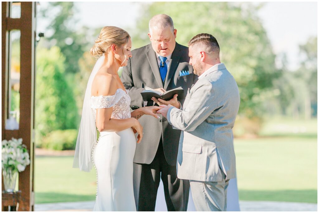 Bride and Groom exchange rings at Grand National Wedding | Opelika AL Wedding Photography by Amanda Horne
