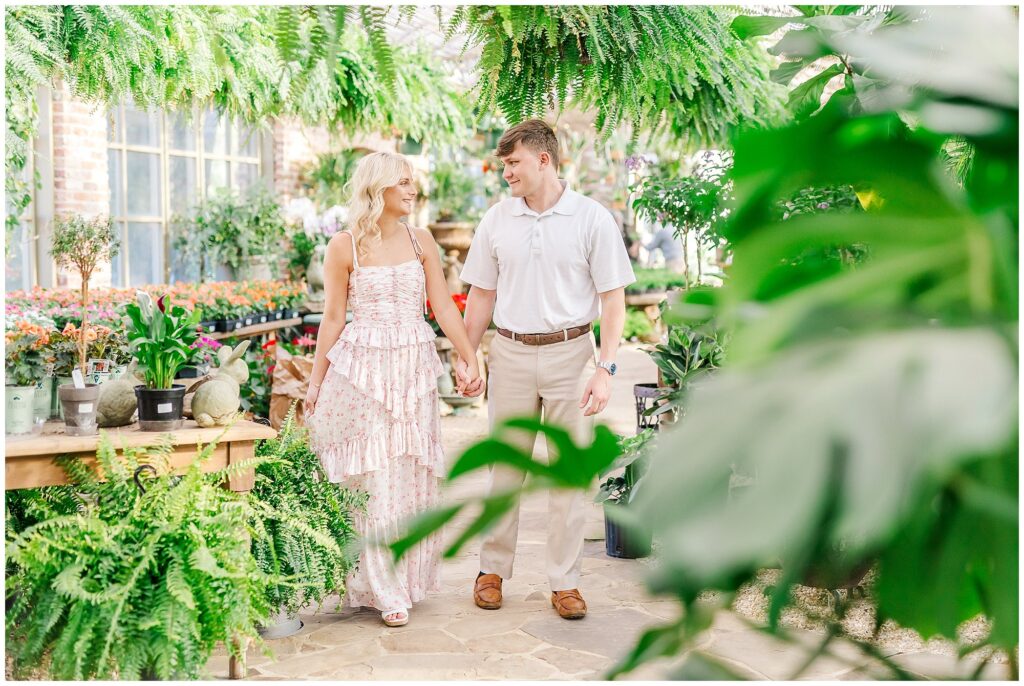 Couple walking through the Greenhouse at Botanic in Opelika | Alabama Wedding Photographer Amanda Horne