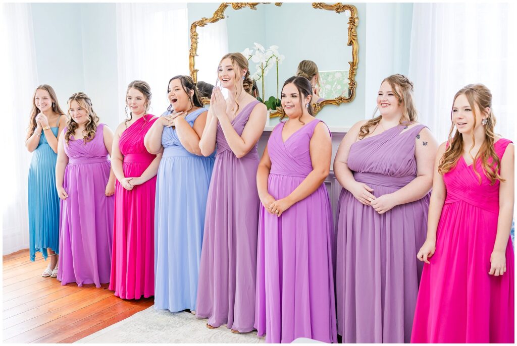 Bridesmaids wearing colorful dresses see bride for the first time | Coosada Alabama Wedding Photographer Amanda Horne