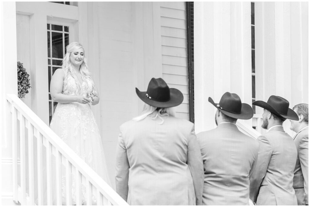 Black and white image of bride sharing first look with her dad and brothers | Coosada Alabama Wedding Photographer Amanda Horne