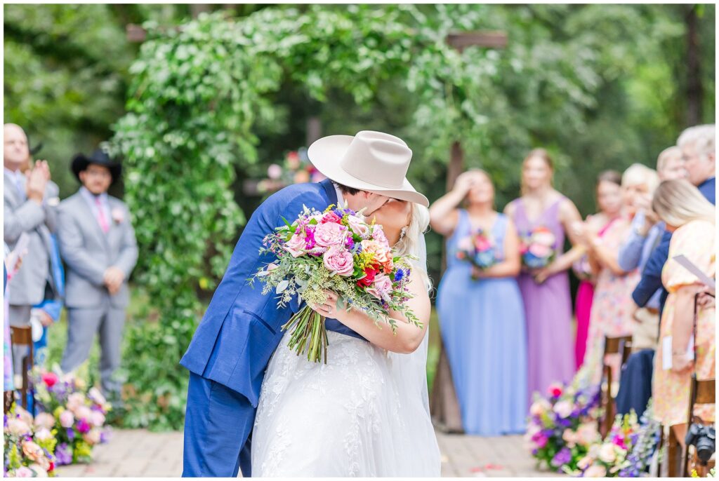 Bride and groom kiss in aisle | Coosada Alabama Wedding Photographer Amanda Horne