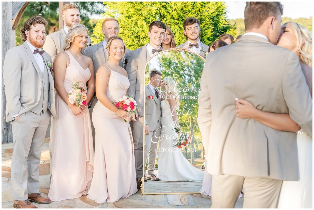 Bride and groom reflected in mirror with bridal party surrounding | Lake Martin Wedding Photographer Amanda Horne