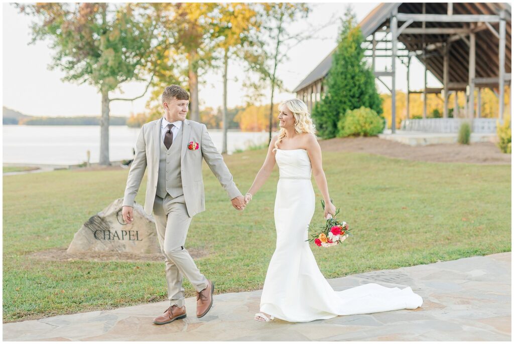 Bride and groom walking in front of Chapel at New Water Farms | Lake Martin Wedding Photographer Amanda Horne