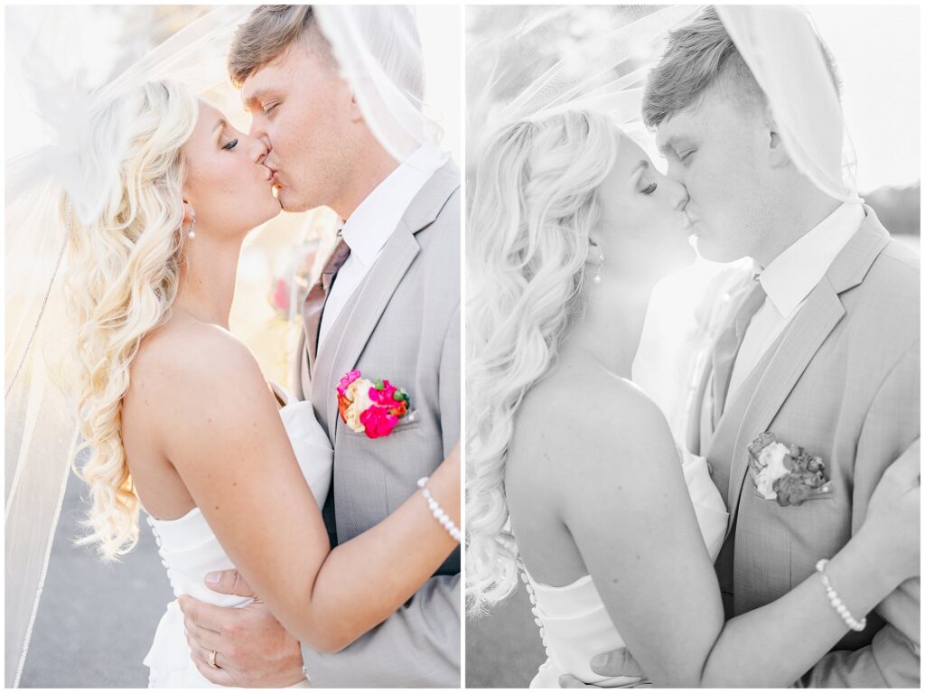 Bride and groom share a kiss under cathedral length veil | Lake Martin Wedding Photographer Amanda Horne