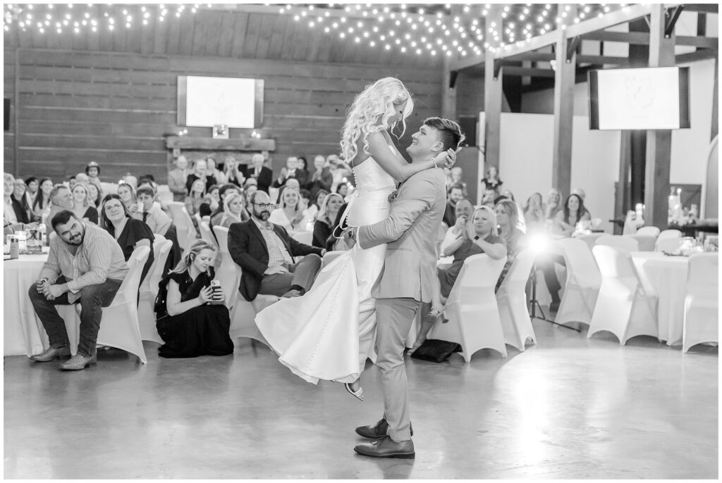 Groom lifting bride during first dance at New Water Farms | Lake Martin Wedding Photographer Amanda Horne