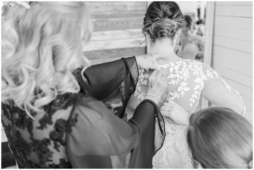 Bride's mother helping her into wedding dress at the Farm at Lullwater in Opelika AL | Alabama Wedding Photographer Amanda Horne