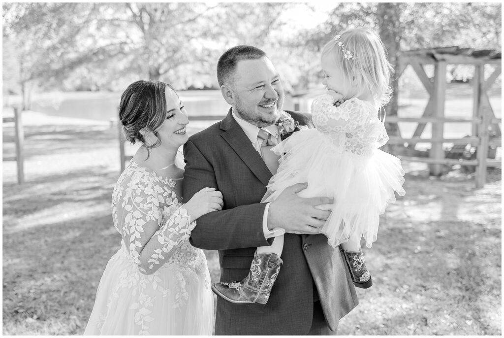 Laughing bride and groom with daughter | Alabama Wedding Photographer Amanda Horne