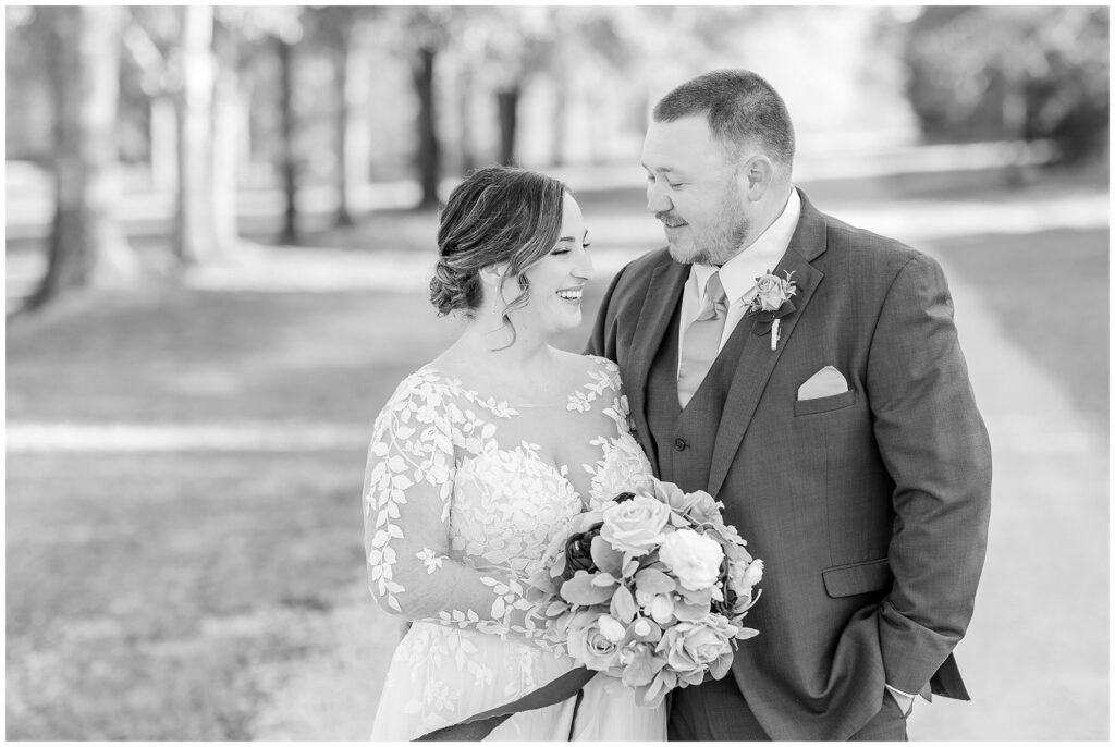 Black and white photo of groom with laughing bride | Alabama Wedding Photographer Amanda Horne