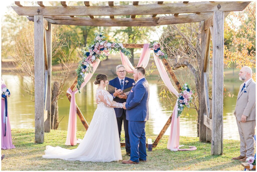 Bride and groom with officiant during December wedding ceremony | Alabama Wedding Photographer Amanda Horne