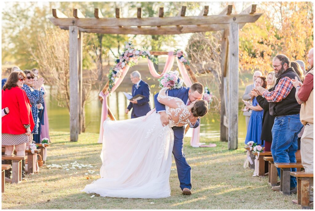 Bride and groom dip kiss in aisle | Alabama Wedding Photographer Amanda Horne