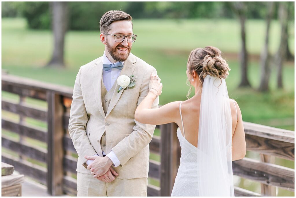 Groom smiling at bride during first look