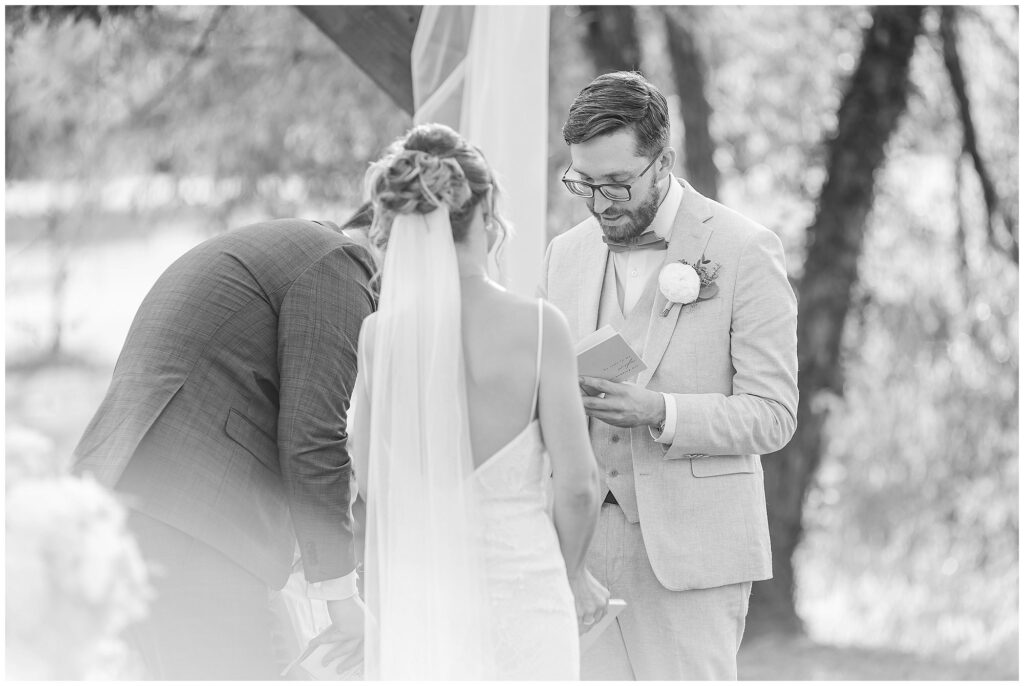 Bride and groom exchanging vows at their summer wedding