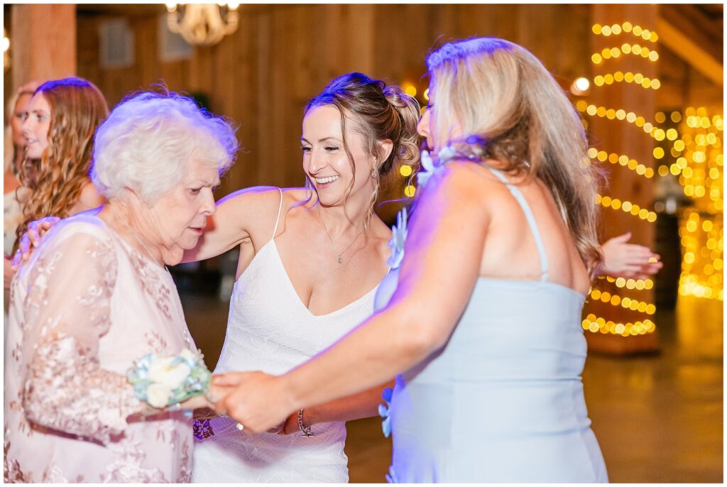 Bride’s grandmother dancing with family at reception