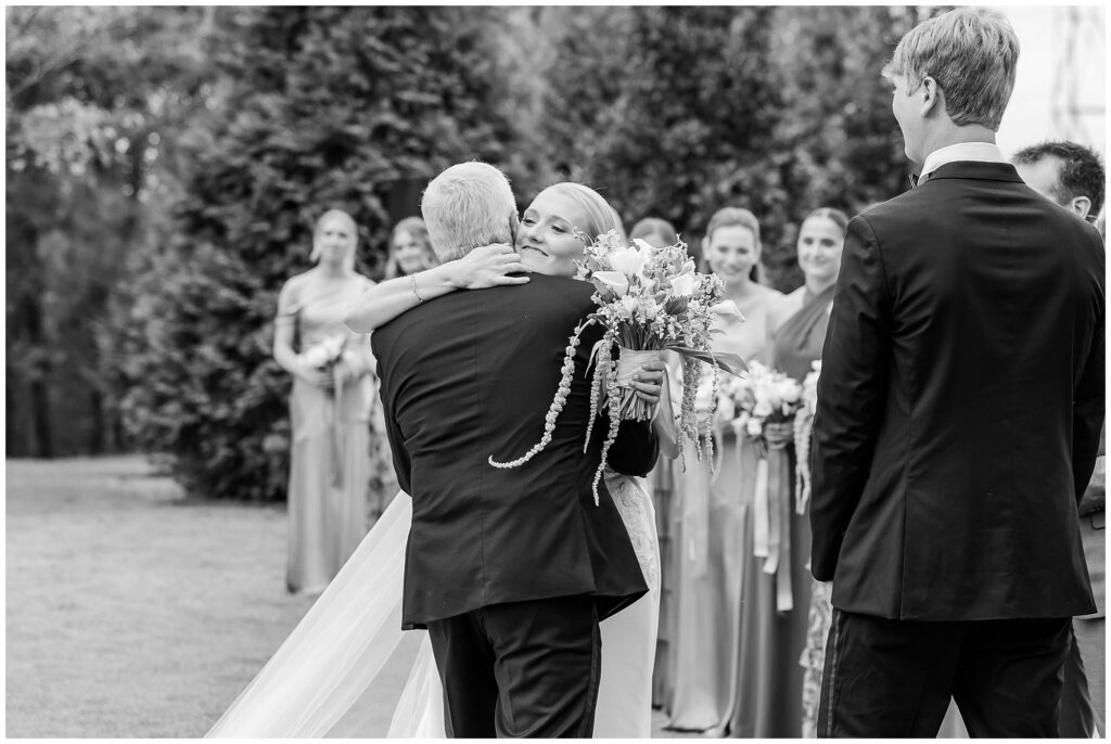 Bride embracing father as he gives her away