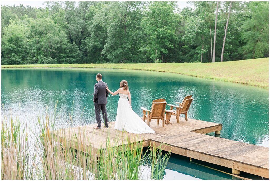 Bride and groom sharing a first look on a pond pier, wedding trends worth keeping