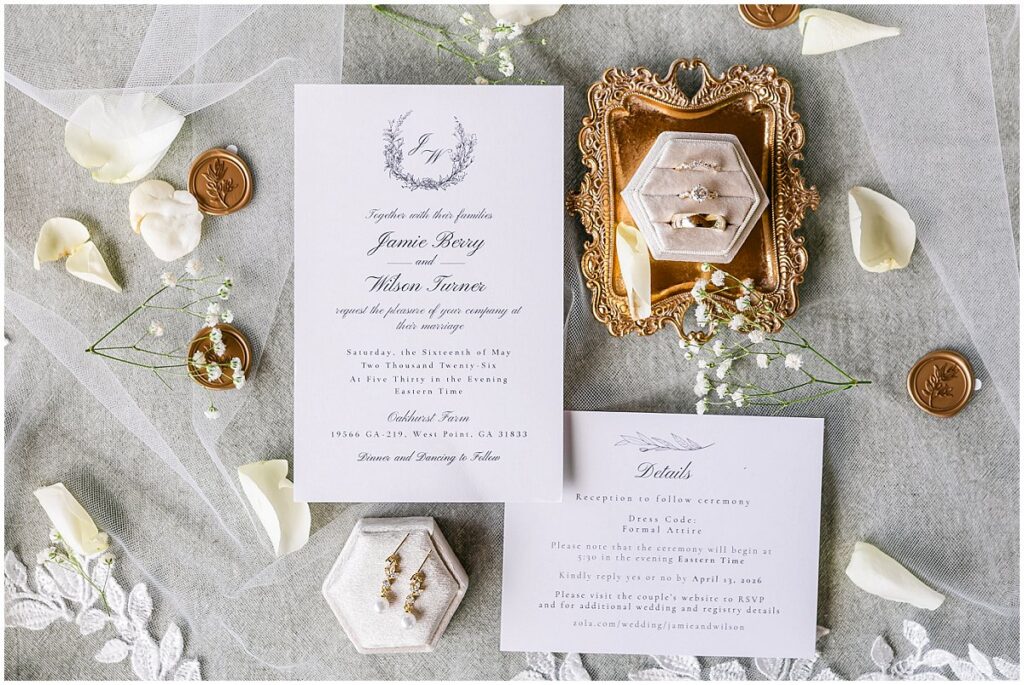 Bridal details including rings and invitations at an Oakhurst wedding