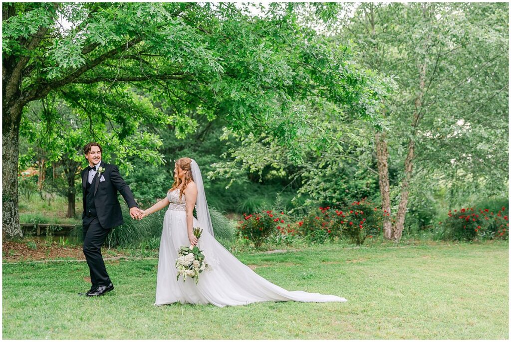 Bride and groom holding hands at their Oakhurst wedding
