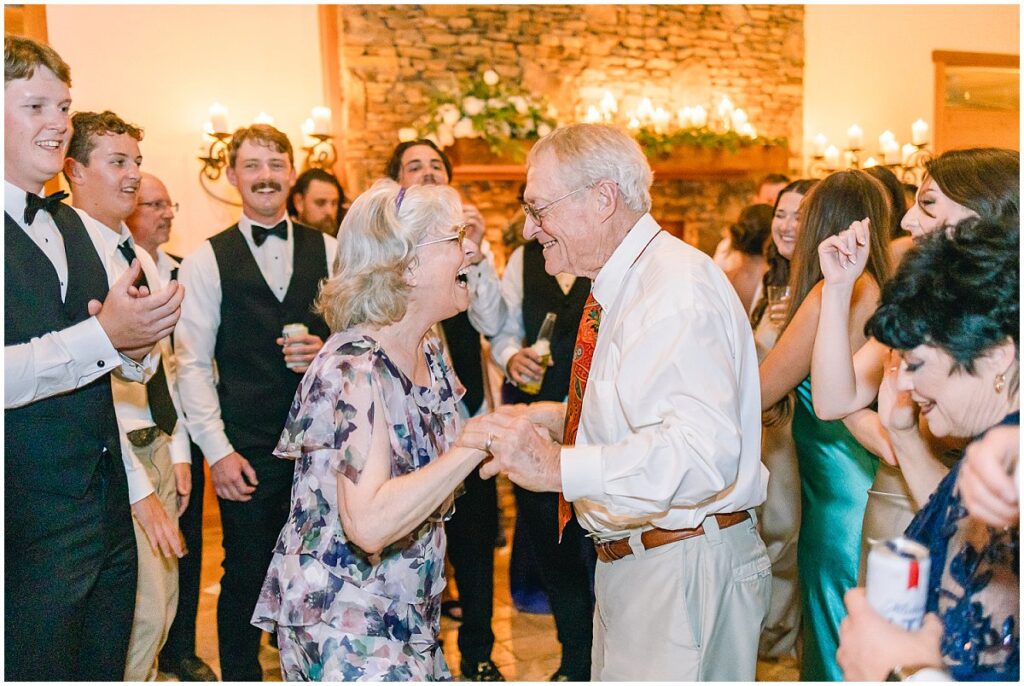 Wedding guests and grandparents dancing at the reception
